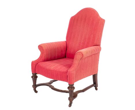 A Victorian upholstered armchair in Queen Anne taste, late 19th century,cerise upholstered, with arched back and outscrolled 