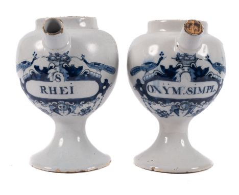 A pair of Dutch delftware blue and white wet drug jars the 'peacock' labels inscribed 'S Rhei' and 'Oxym:Simpl', one with mar