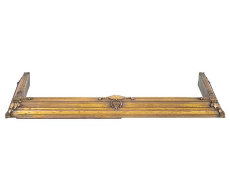 A brass fender in Arts & Crafts style, circa 1900; of rectangular form; the step moulded front and sides with stylised scroll