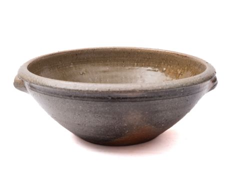 *Svend Bayer [b. 1946] a stoneware basin of circular form with everted rim and two lug handles with salt glazed exterior the 