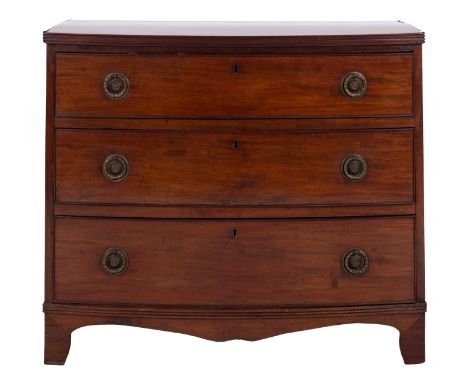 A Regency mahogany bowfront chest of drawers, early 19th century; the top with reeded edges, above three graduated drawers, a