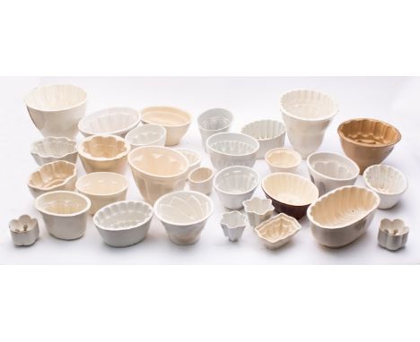 A large quantity of pottery jelly moulds of various shapes, comprising examples by Maling, Shelley and others including some 