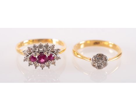 A group of two rings, including an 18ct gold ring set with three circular-cut rubies with a surround of brilliant-cut diamond