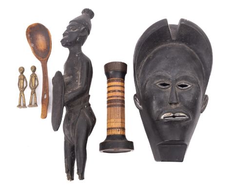 A small collection of ethnographica, 20th century; including an African carved ebony mask, of stylised form, with pierced eye