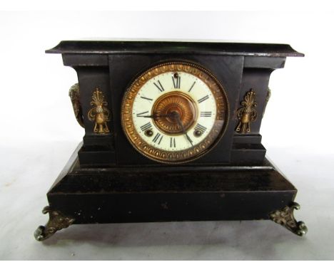 A Victorian cast iron mantle clock to simulate slate with applied gilded detail enclosing an eight day striking movement