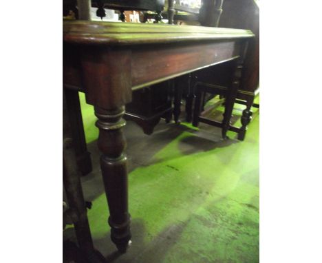 A 19th century mahogany side/centre table of rectangular form with moulded outline and rounded corners raised on four turned 