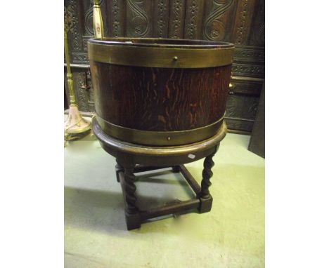 An R A Lister & Co Ltd coopered and brass banded jardiniere raised on a low stand with spiral twist column supports united by