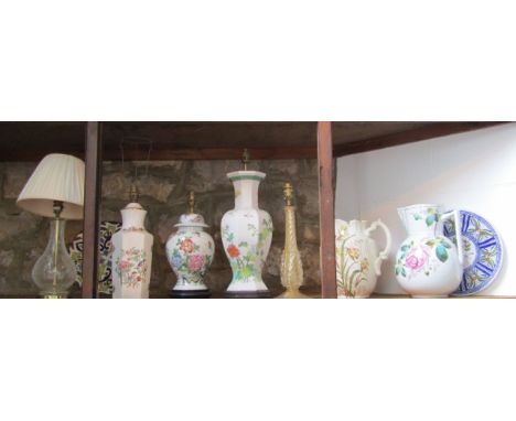 A collection of ceramic and glass lamp bases including examples with chinoiserie type floral decoration, a crackle glass exam