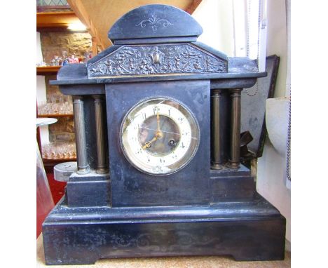 A Victorian black slate mantle clock in a classical style with eight day striking movement