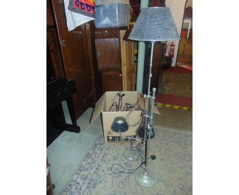 A Contemporary tubular steel adjustable standard lamp, with disc shaped base, a matching two-branch table lamp, both with sim