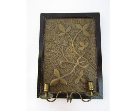 Lighting; A wall mounted beaten brass panel depicting stylised foliage, loosely in the Arts & Crafts manner, set within a sim