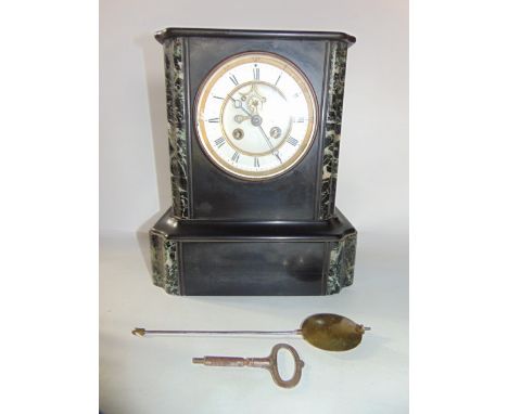 A Victorian black slate and marble mantle clock, with visible escapement and eight-day striking movement