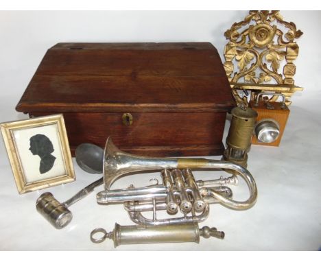 A simple antique stained pine writing slope, the hinged lid with a hollow interior accommodating a silver plated trumpet with