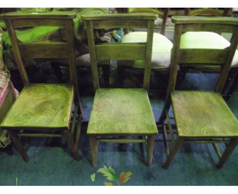 Three vintage elm and beech wood chapel chairs with saddle shaped seats and hymn book receptacles 