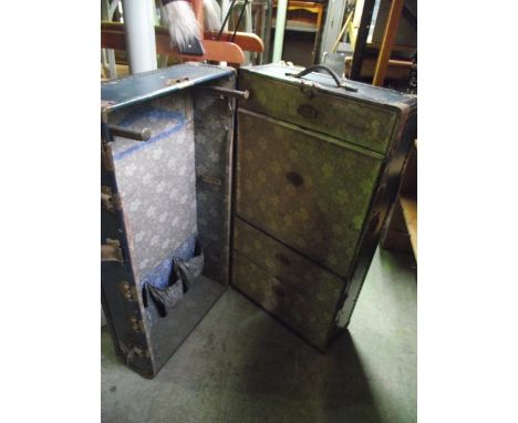 A vintage blue coloured fibre and re-inforced cabin/wardrobe trunk, the floral printed lined interior partially fitted with d