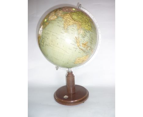 A 20th century terrestrial desktop globe raised on a turned timber support with circular base accommodating an inset compass