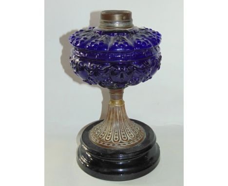 A late 19th century oil lamp, with transparent blue moulded glass reservoir 