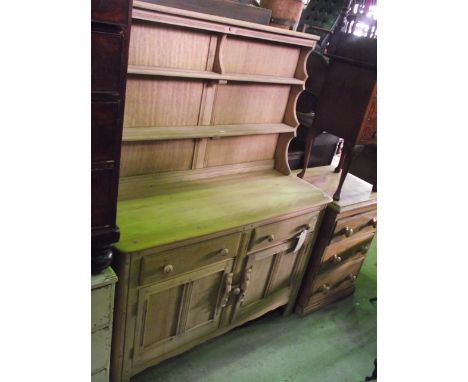 Stripped Ercol dresser, enclosed by two panelled doors and two drawers with plate rack over