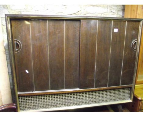 A vintage, probably mid 20th century, floorstanding radiogram by Grundig, the walnut veneered case with two sliding doors rev