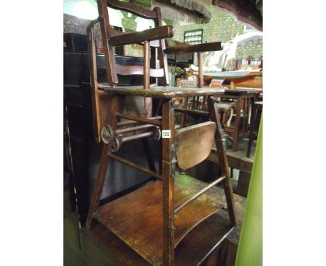 A vintage child's metamorphic high chair with wavy ladderback and stained beechwood frame