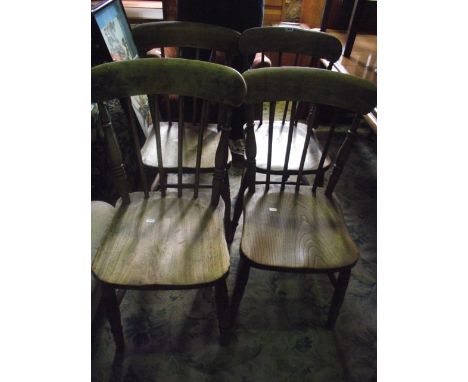 A set of four vintage Windsor elm and beech wood stick back kitchen chairs raised on turned supports and stretchers