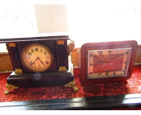 An Art Deco mantle clock, the walnut case cross banded in rosewood enclosing a three train movement with strike/silent select