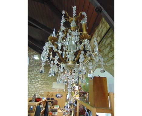 A decorative contemporary six branch electrolier with hanging clear cut droplets, with gilt effect framework and further fini