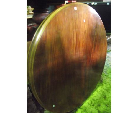 A Victorian mahogany tilt top breakfast table of circular form with moulded outline raised on a central turned pillar and scr