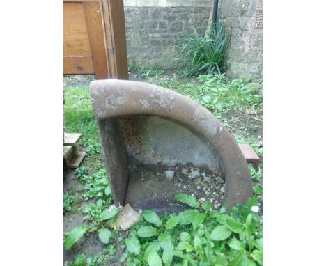A small vintage cast iron wall mounted corner feeding trough