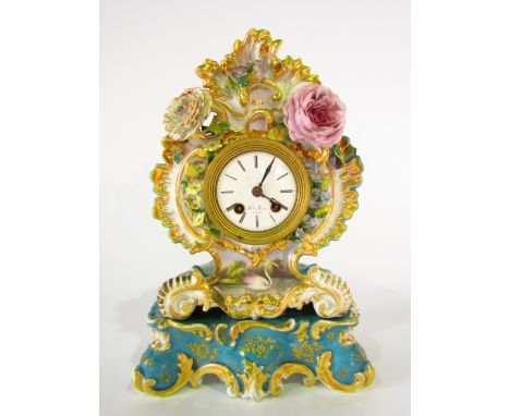 A 19th century French two train mantel clock by Henry Marc of Paris in ceramic case of scrolling and floral encrusted form wi