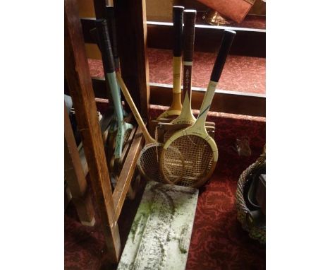 A Regency white marble panel with urn detail, together with a number of vintage tennis racquets 