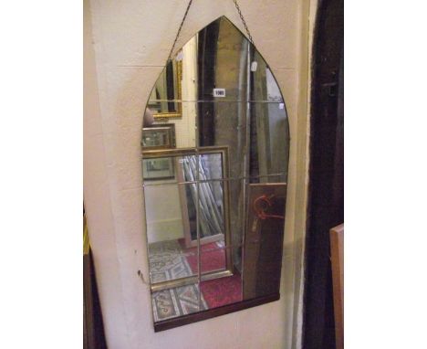 A vintage frameless wall mirror of lancet shaped form with slice cut plate 