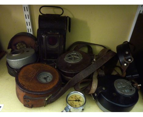 Four heavy duty leather and other cased gauges/meters together with a wall hanging lantern with bevelled glass panelled sides