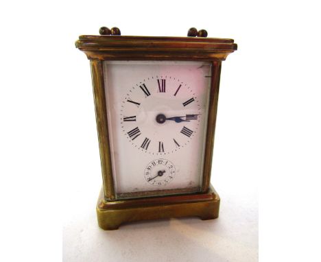 A brass carriage clock with eight day movement and alarm, with original red leather carrying case