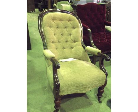 A Victorian spoonback drawing room chair with open arms, upholstered seat and button back within a shaped and moulded frame r