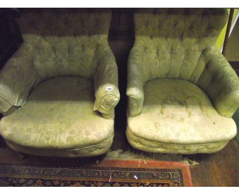 A pair of mid Victorian button back drawing room chairs, raised on turned supports