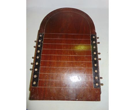 A good quality vintage bagatelle board, principally in mahogany with inlaid borders and ebony sides with rolling printed aper
