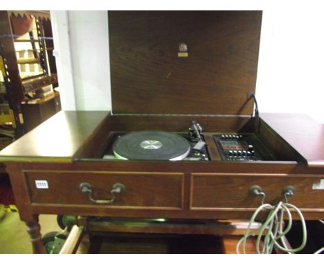 A radiogram, the case in the form of an old English style oak side table with two mock frieze drawers and central hinged lid 