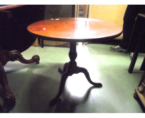A 19th century mahogany snap top occasional table of circular form raised on a turned pillar and shaped tripod