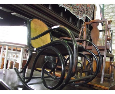 A vintage Bentwood rocking chair with ebonised frame and pierced plywood seat and back together with a low hexagonal occasion