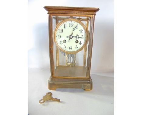 A 19th century brass and four pane mantle clock, with eight-day striking movement and mercury pendulum