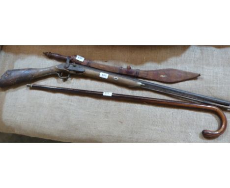 An ethnic sword with leather scabbard, a percussion rifle (A.F.) and a walking stick