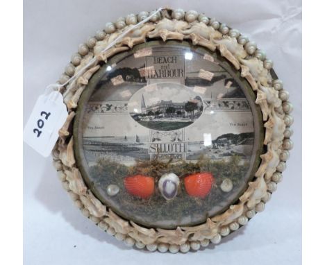 An Edwardian shell-work souvenir diorama, with monochrome lithograph depicting the Beach and Harbour at Silloth, mounted with