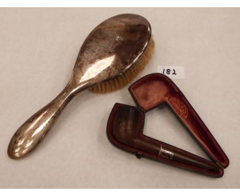 A silver hairbrush and a cased tobacco pipe and silver collar