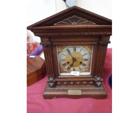 An early 20th century oak mantle clock in architectural case. 16' high