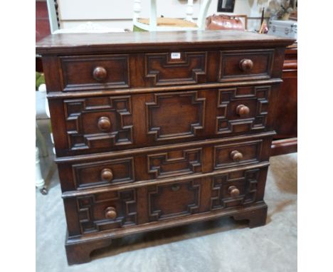A Jacobean oak chest, in two parts, with four geometrically moulded long drawers, raised on bracket feet. 44' wide