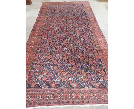 A Persian carpet with blue and red gul field. 146' x 77'