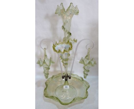 A Victorian vaseline glass epergne, hung with two glass baskets on scrolled clear glass cane supports 22½' high. Centre trump