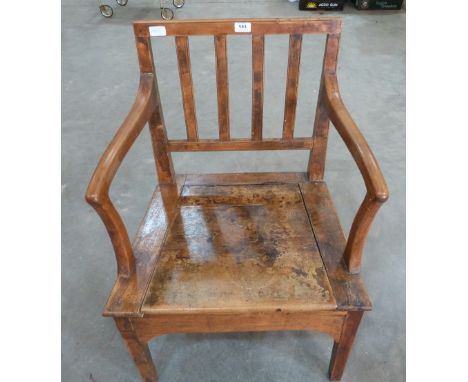 A George III fruitwood commode elbow chair.