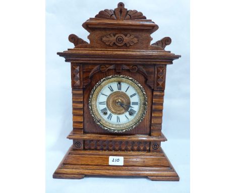 An American oak mantle clock bearing label for The Ansonia Clock Company. 17½' high